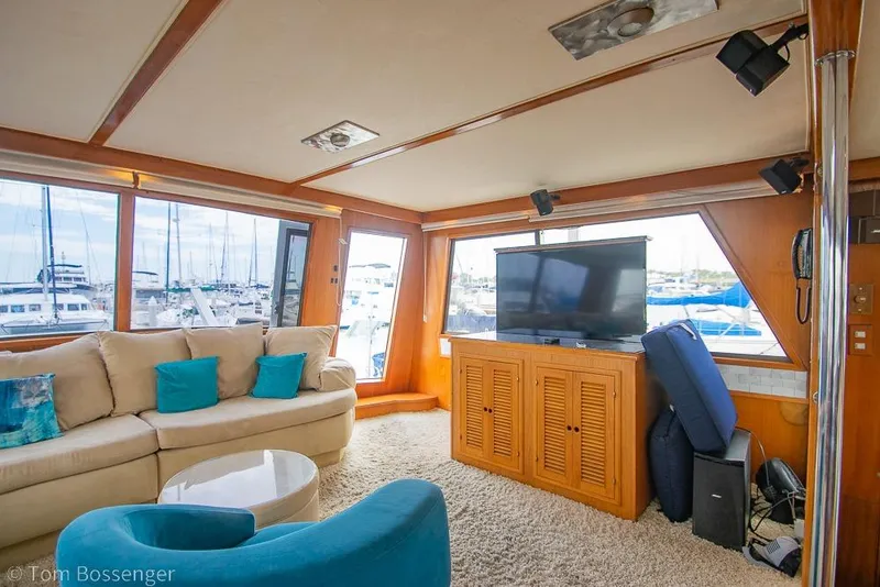 Slide: The Image of Luxurious interior of 1990 Kha Shing Flush Deck Motor Yacht with cozy seating and marina view. - 11