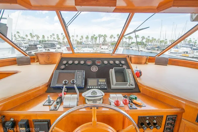 Slide: The Image of Cockpit of 1990 Kha Shing Flush Deck Motor Yacht with navigation instruments and marina view. - 37