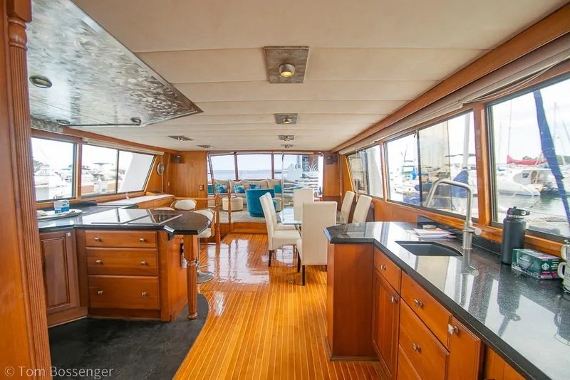 Slide: The Image of Luxurious interior of 1990 Kha Shing Flush Deck Motor Yacht with wooden flooring and modern amenities. - 2