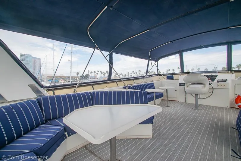 Slide: The Image of Spacious interior of 1990 Kha Shing Flush Deck Motor Yacht with blue seating and tables. - 42