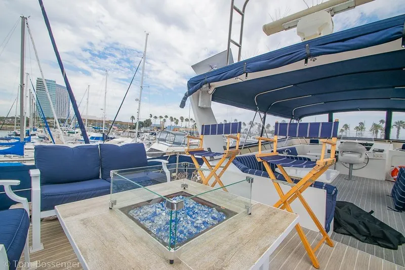Slide: The Image of Luxurious 1990 Kha Shing Flush Deck Motor Yacht with elegant seating and marina view. - 54
