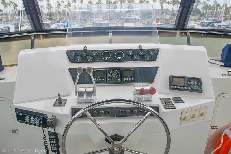 Slide: The Image of Cockpit of 1990 Kha Shing Flush Deck Motor Yacht with steering wheel and control panel. - 47