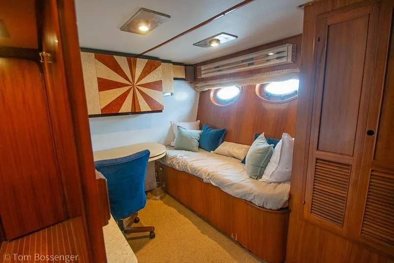 Slide: The Image of Luxurious 1990 Kha Shing Flush Deck Motor Yacht interior with cozy seating and elegant wood finishes. - 34