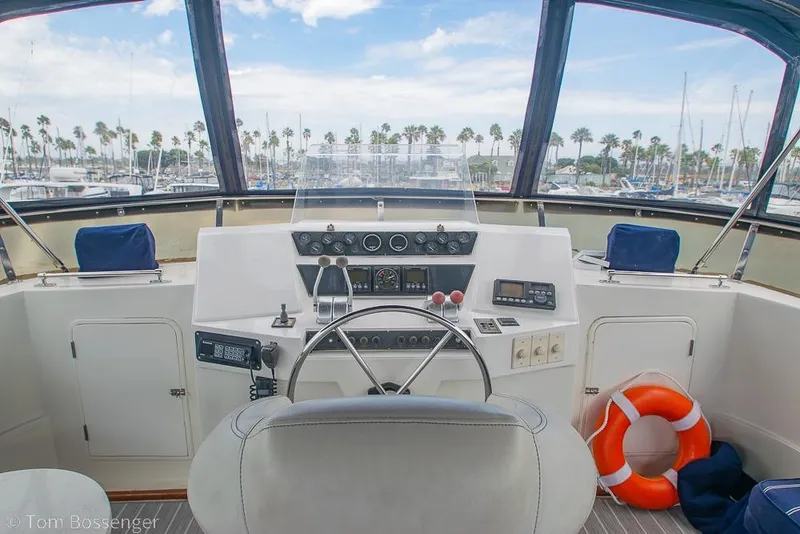Slide: The Image of Cockpit view of 1990 Kha Shing Flush Deck Motor Yacht with steering wheel and controls. - 46