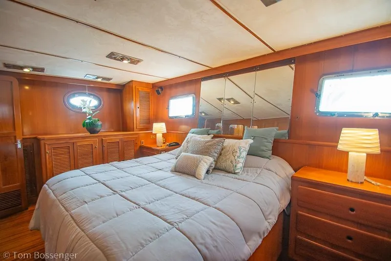 Slide: The Image of Luxurious 1990 Kha Shing Flush Deck Motor Yacht bedroom with elegant wood paneling. - 18