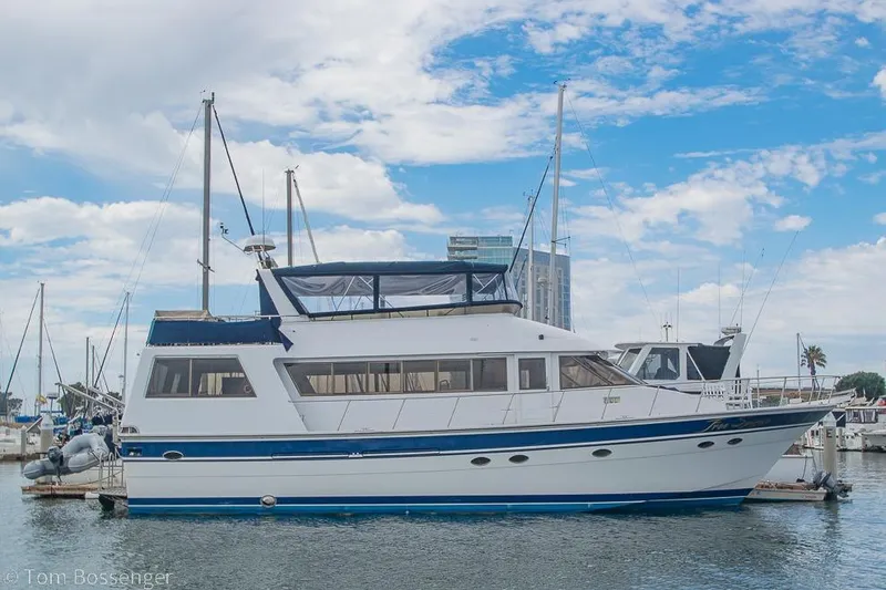 The Image of 1990 Kha Shing Flush Deck Motor Yacht docked at marina under blue sky. - 0