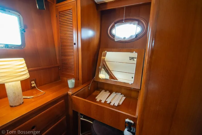 Slide: The Image of Interior of 1990 Kha Shing Flush Deck Motor Yacht with wooden cabinetry and vanity mirror. - 21