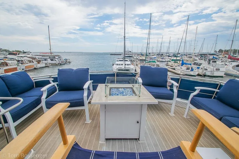 Slide: The Image of Luxurious 1990 Kha Shing Flush Deck Motor Yacht with elegant seating and marina view. - 51