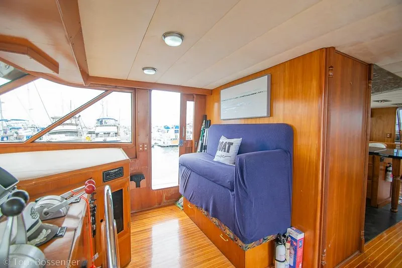 Slide: The Image of Interior of 1990 Kha Shing Flush Deck Motor Yacht with wooden paneling and blue seating. - 40
