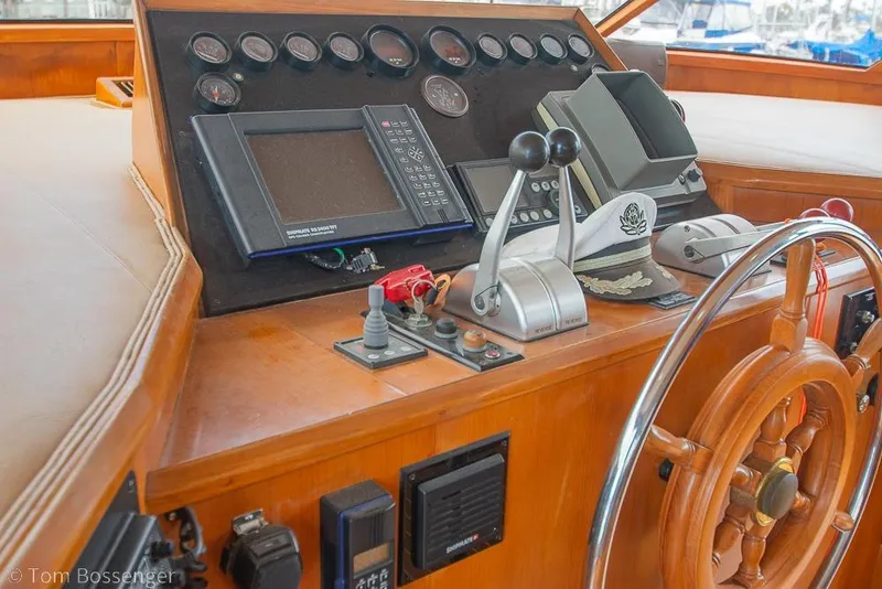Slide: The Image of Control panel of a 1990 Kha Shing Flush Deck Motor Yacht with steering wheel. - 38