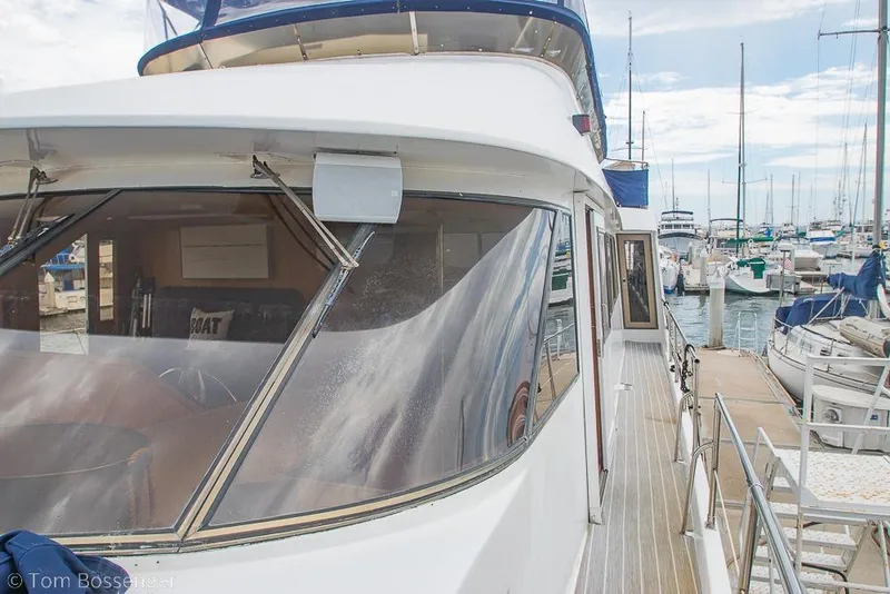 Slide: The Image of 1990 Kha Shing Flush Deck Motor Yacht docked at a marina. - 60