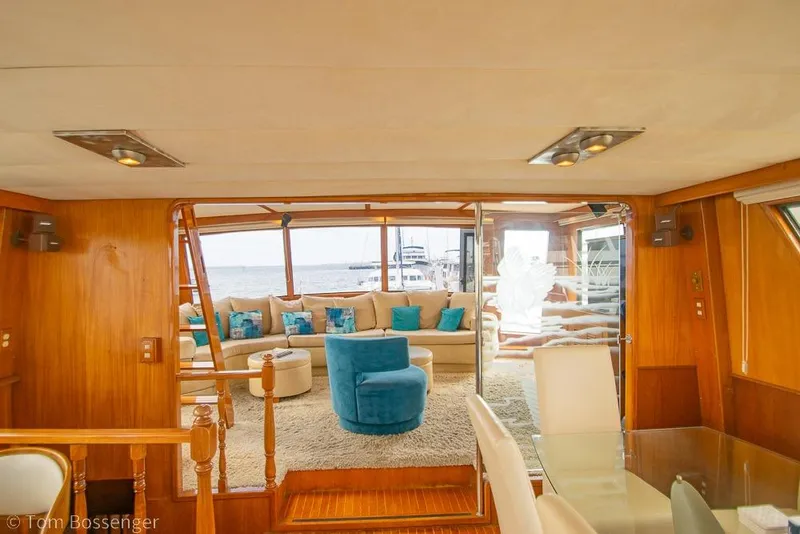 Slide: The Image of Luxurious interior of 1990 Kha Shing Flush Deck Motor Yacht with elegant seating and wood finishes. - 9
