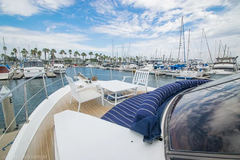 Slide: The Image of 1990 Kha Shing Flush Deck Motor Yacht docked in a marina with outdoor seating. - 55