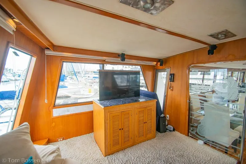 Slide: The Image of Interior of 1990 Kha Shing Flush Deck Motor Yacht with TV and wooden cabinetry. - 14