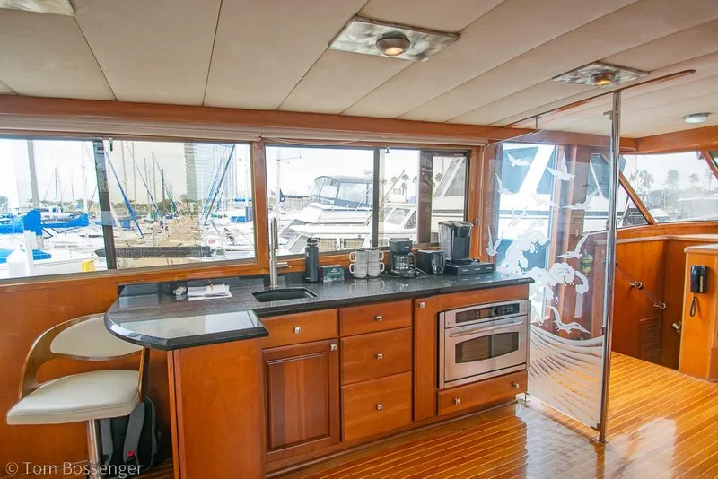 Slide: The Image of Interior of 1990 Kha Shing Flush Deck Motor Yacht with modern kitchen amenities. - 4