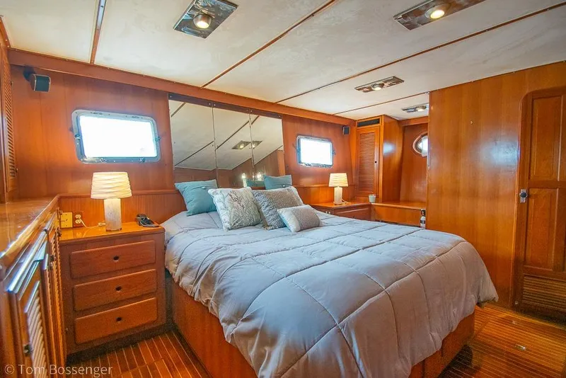 Slide: The Image of Luxurious bedroom interior of 1990 Kha Shing Flush Deck Motor Yacht with wooden furnishings. - 17