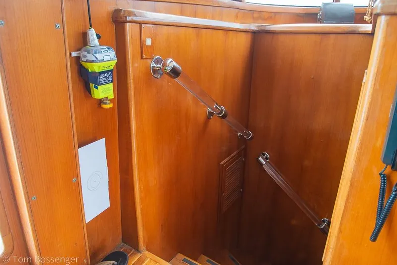 Slide: The Image of Interior of 1990 Kha Shing Flush Deck Motor Yacht with wooden stairs and safety equipment. - 27