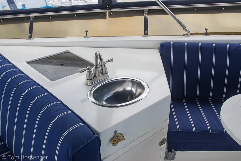 Slide: The Image of 1990 Kha Shing Flush Deck Motor Yacht interior with sink and striped seating. - 44