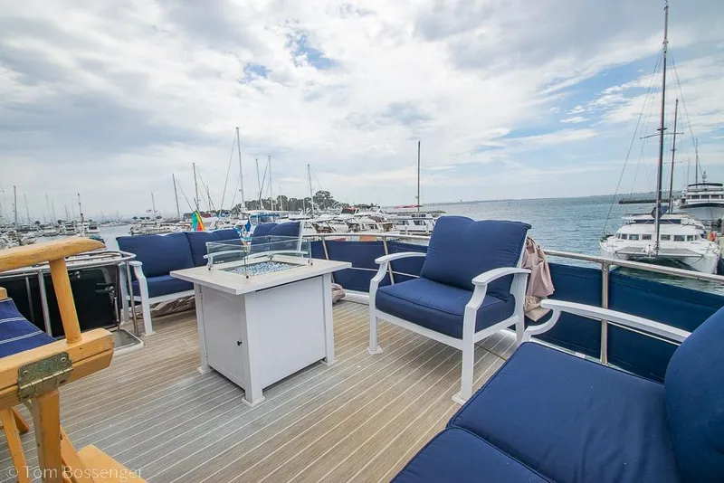 Slide: The Image of Deck of 1990 Kha Shing Flush Deck Motor Yacht with blue seating and ocean view. - 53