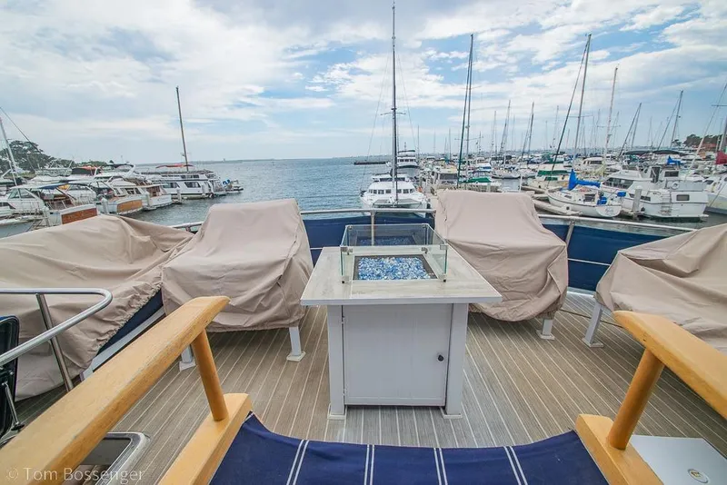 Slide: The Image of Deck view of a 1990 Kha Shing Flush Deck Motor Yacht in a marina setting. - 50