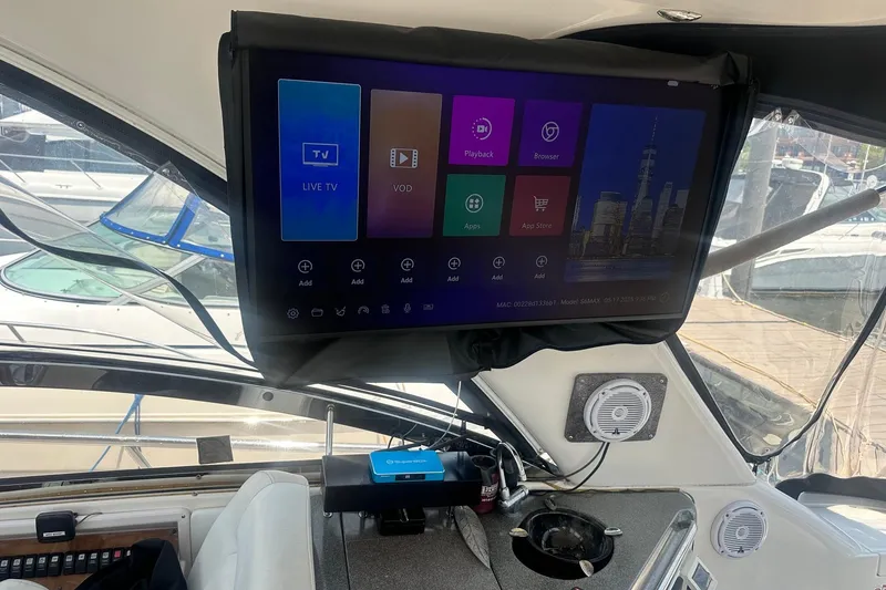 Slide: The Image of Interior of a 2005 Regal Commodore 4060 yacht with a mounted TV screen. - 13