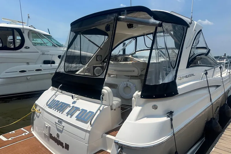 Slide: The Image of 2005 Regal Commodore 4060 yacht docked, featuring sleek design and spacious interior. - 7