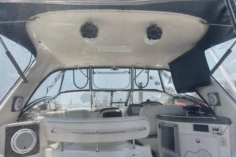 Slide: The Image of Interior view of a 2005 Regal Commodore 4060 yacht cockpit with seating and control panel. - 9
