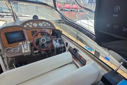 Slide: The Image of Interior view of a 2005 Regal Commodore 4060 yacht cockpit with steering wheel and control panel. - 24