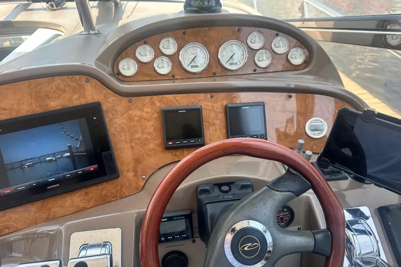 Slide: The Image of Dashboard of a 2005 Regal Commodore 4060 boat with navigation screens and gauges. - 22