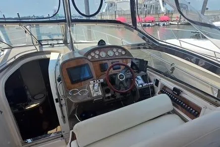 Slide: The Image of Cockpit of 2005 Regal Commodore 4060 yacht with steering wheel and navigation controls. - 20