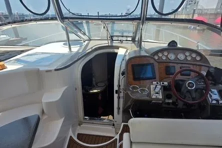 Slide: The Image of 2005 Regal Commodore 4060 yacht cockpit with steering wheel, control panel, and seating. - 16