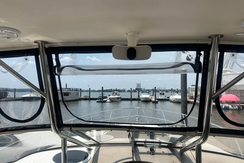 Slide: The Image of View from a 2005 Regal Commodore 4060 yacht cockpit overlooking a marina. - 18