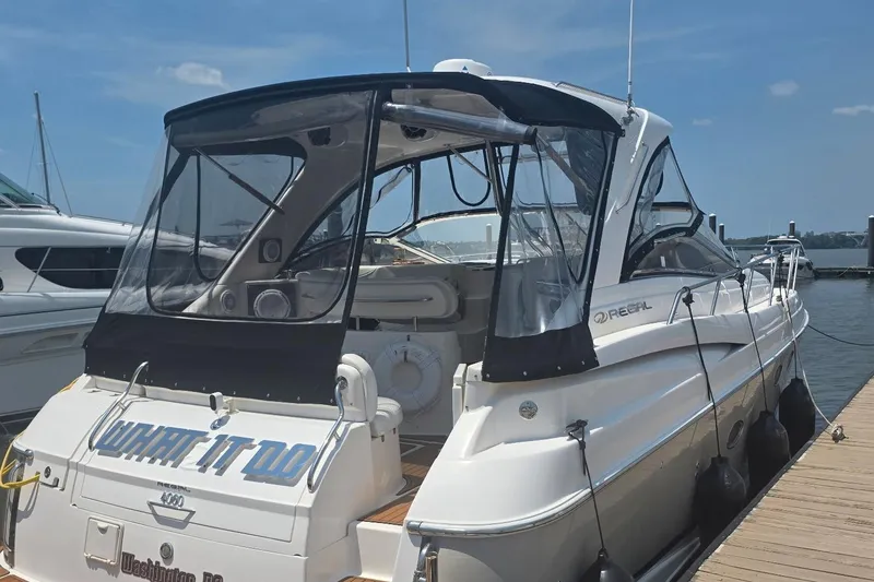Slide: The Image of 2005 Regal Commodore 4060 yacht docked at marina under clear blue sky. - 2