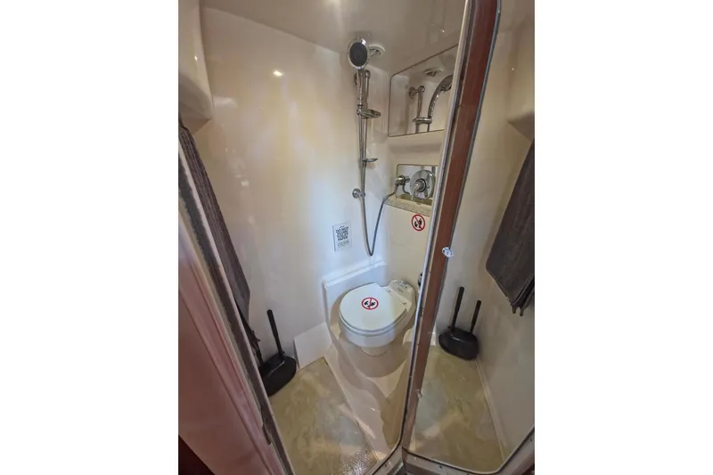 Slide: The Image of Compact bathroom in 2005 Regal Commodore 4060 yacht, featuring shower and toilet. - 29