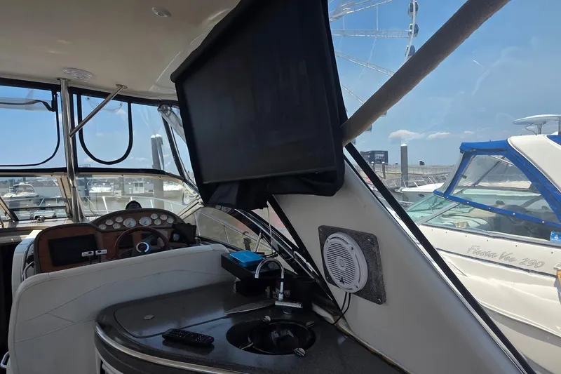 Slide: The Image of Interior of a 2005 Regal Commodore 4060 yacht with dashboard and mounted screen. - 14