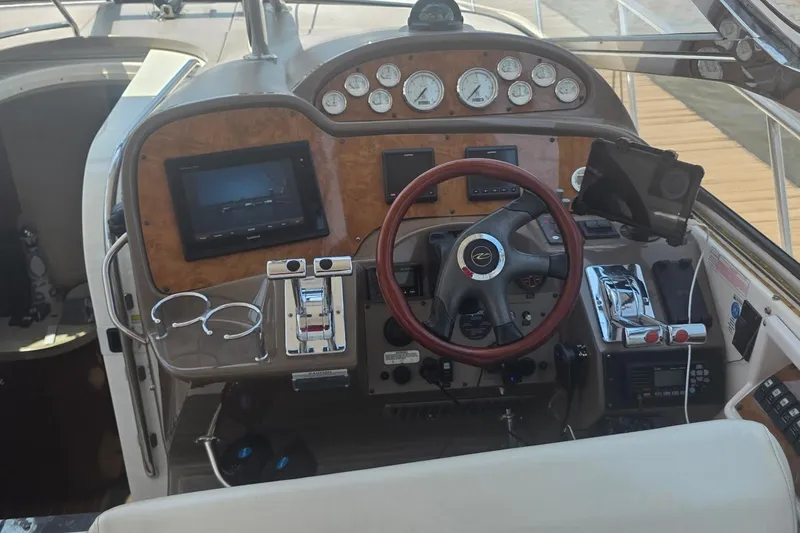 Slide: The Image of Cockpit of 2005 Regal Commodore 4060 boat with steering wheel and control panel. - 21