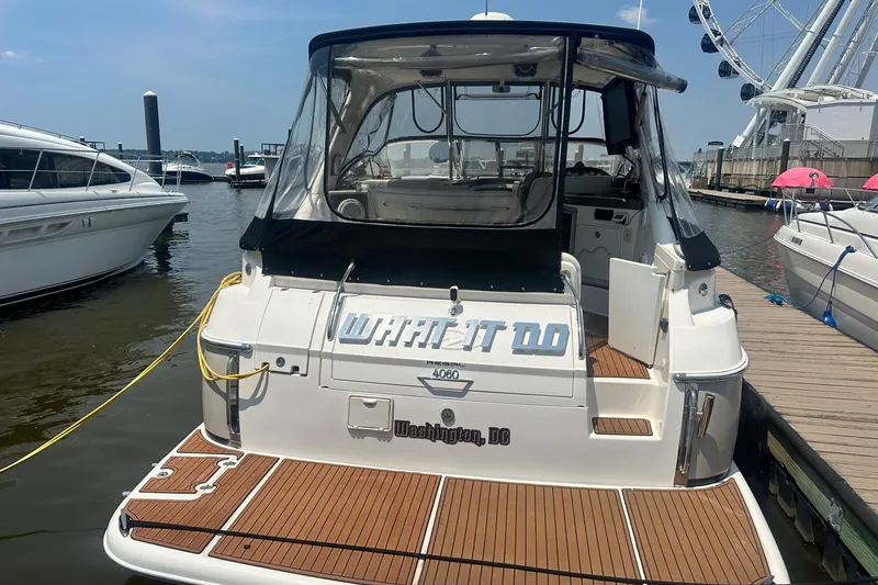 Slide: The Image of 2005 Regal Commodore 4060 yacht docked in Washington, D.C., near a Ferris wheel. - 4
