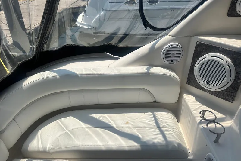 Slide: The Image of Interior of 2005 Regal Commodore 4060 yacht with white seating and built-in speakers. - 11
