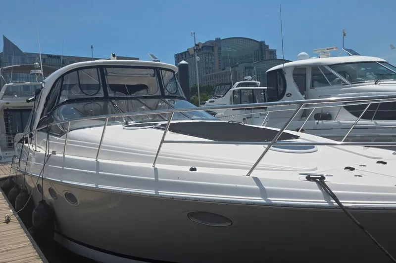 Slide: The Image of 2005 Regal Commodore 4060 yacht docked at marina under clear blue sky. - 3