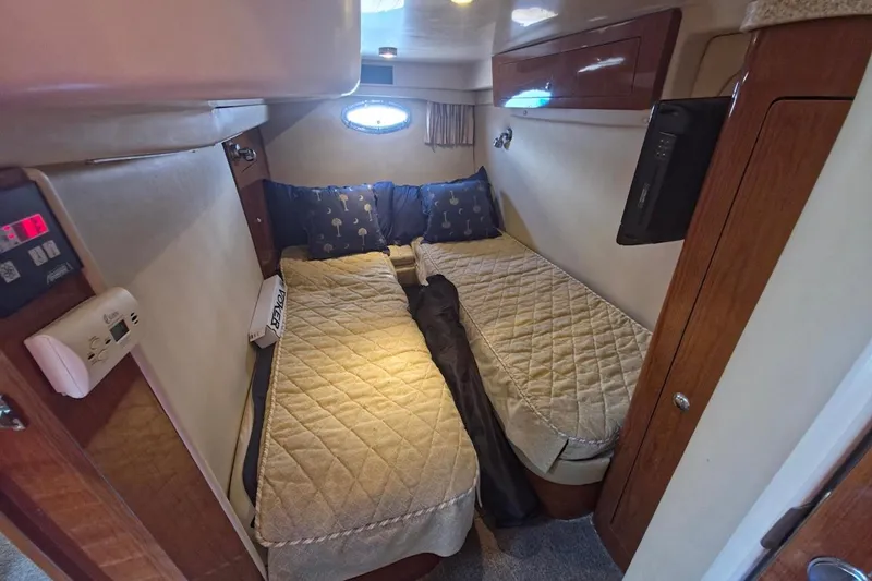 Slide: The Image of Cozy cabin interior of 2005 Regal Commodore 4060 yacht with twin beds and wooden accents. - 27