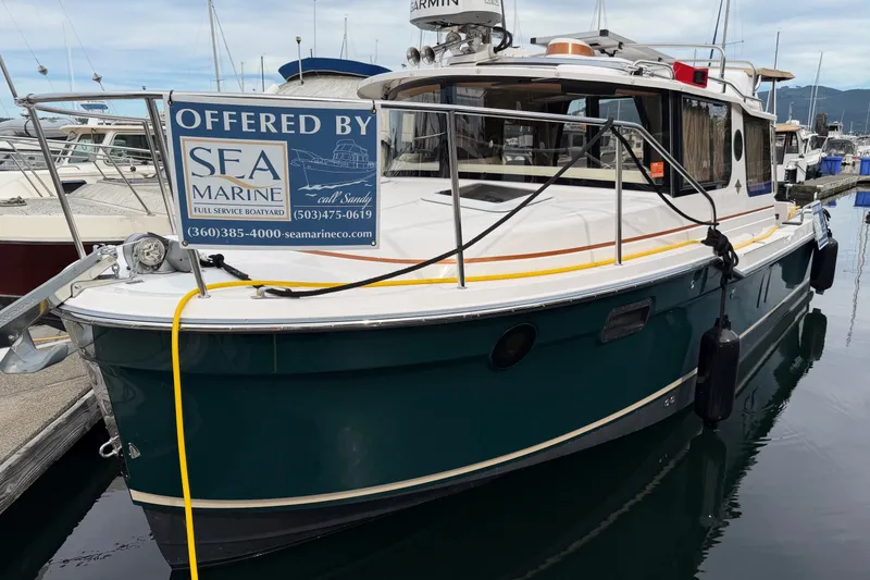 Slide: The Image of 2023 Ranger Tugs R-25 boat docked, offered by SEA Marine, with contact details displayed. - 24
