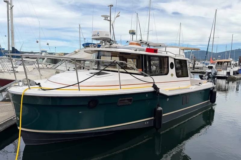 The Image of 2023 Ranger Tugs R-25 boat docked in a marina, featuring a sleek design and modern equipment. - 0