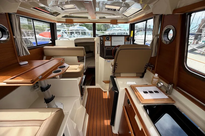 Slide: The Image of Interior of 2023 Ranger Tugs R-25 boat with wood accents and modern amenities. - 9