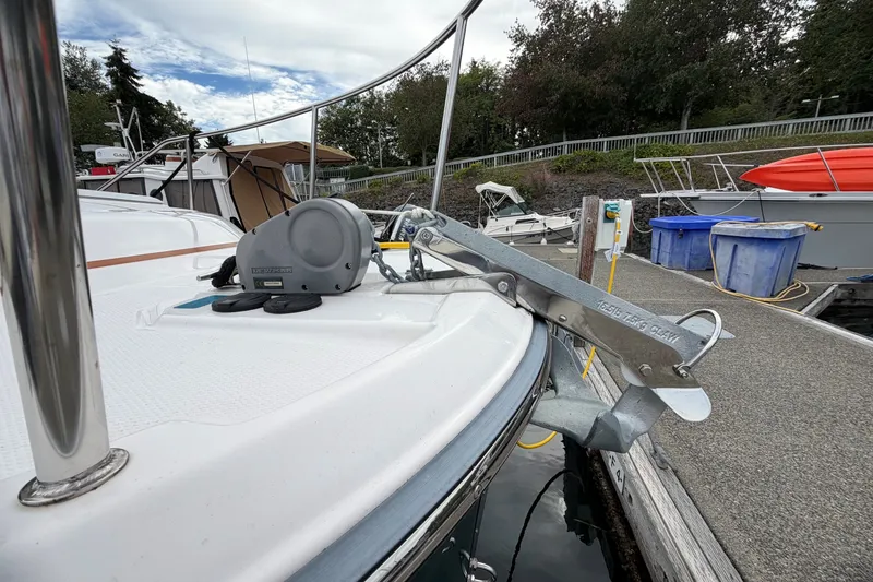 Slide: The Image of 2023 Ranger Tugs R-25 boat anchored at a dock, featuring a secure anchor system. - 3