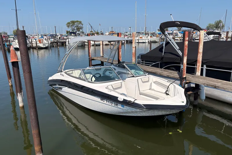 Slide: The Image of 2017 Yamaha AR 190 boat docked in a marina with clear skies. - 4