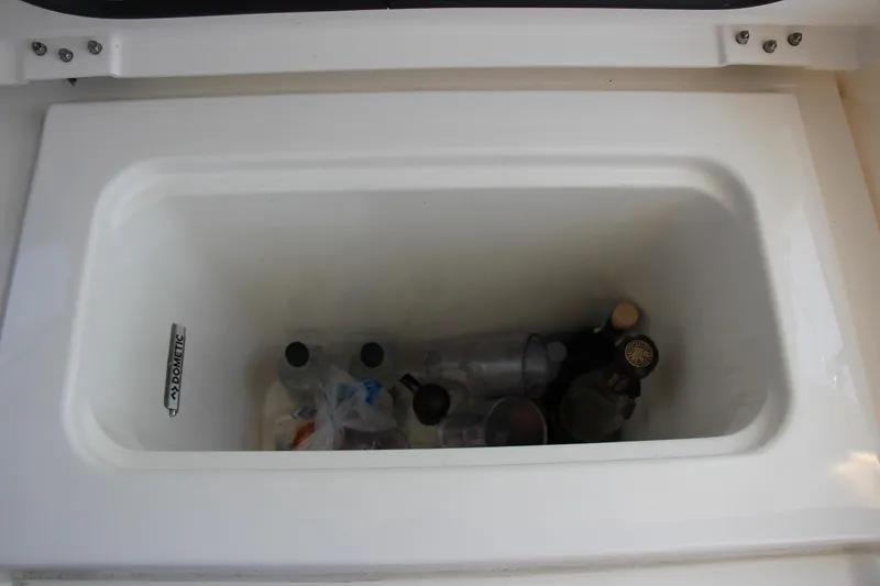 Slide: The Image of Built-in cooler with beverages on 2024 Pursuit OS 405 Offshore boat. - 19