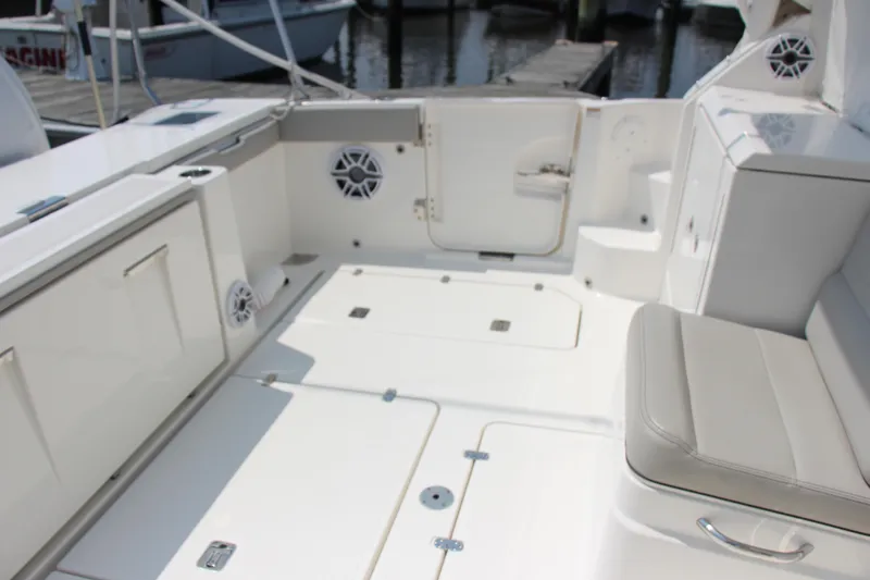 Slide: The Image of 2024 Pursuit OS 405 Offshore boat interior with seating and storage compartments. - 14