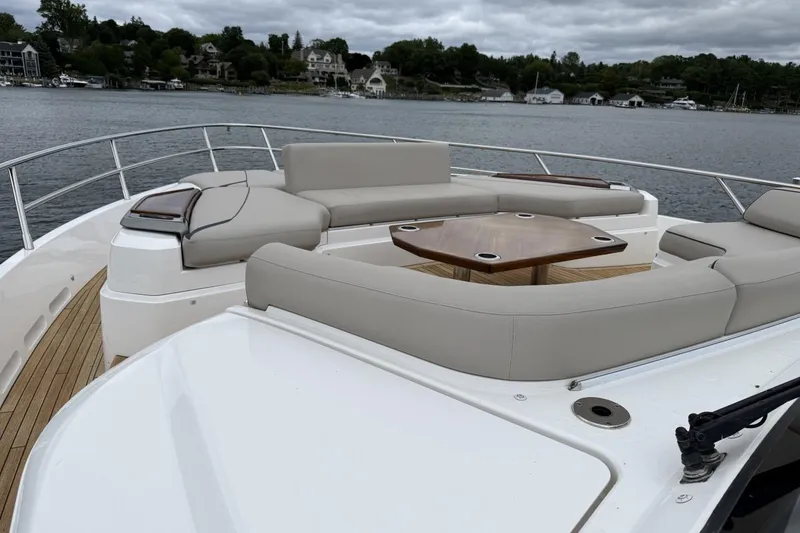 Slide: The Image of Luxurious 2020 Princess S78 yacht deck with elegant seating and scenic waterfront view. - 80