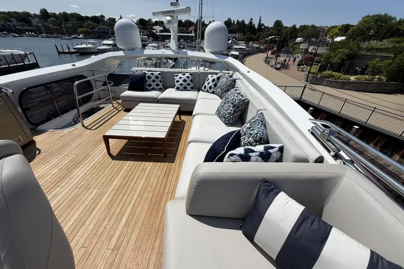 Slide: The Image of Luxurious 2020 Princess S78 yacht deck with elegant seating and scenic marina view. - 74