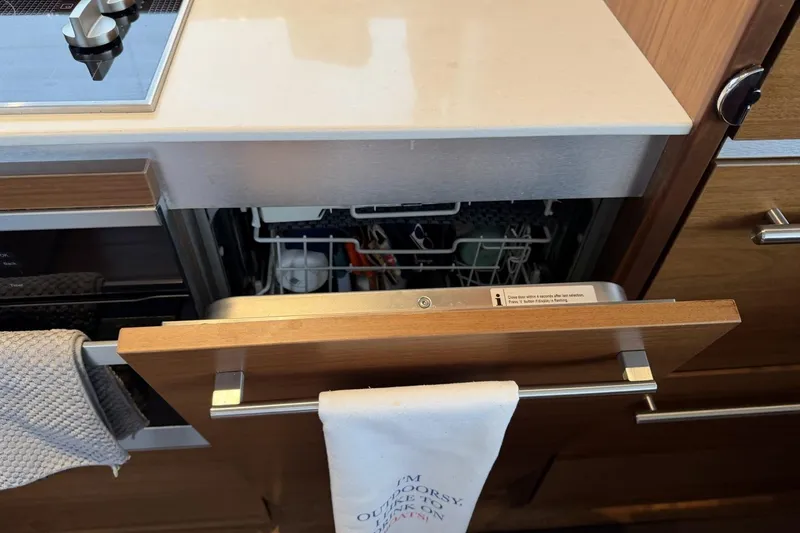 Slide: The Image of Open dishwasher in a 2020 Princess S78 yacht kitchen with wooden cabinetry. - 36